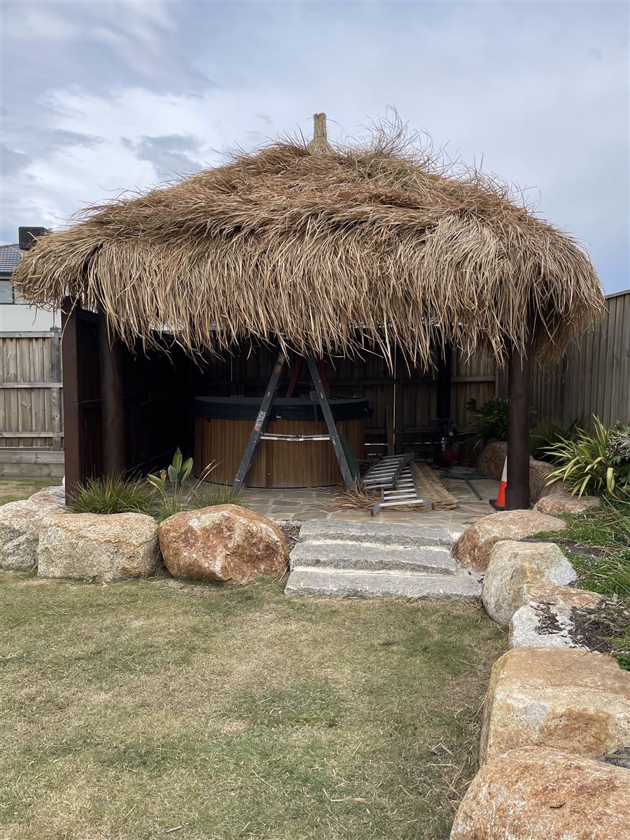 Thatched Bali hut with granite boulder steps and landscaped lawn, built by Sunnybank Horticultural